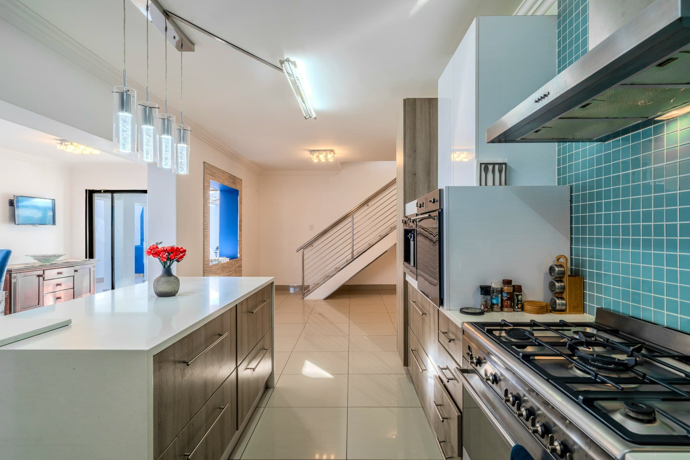 Kitchen with stainless appliances, countertops and a gas hob