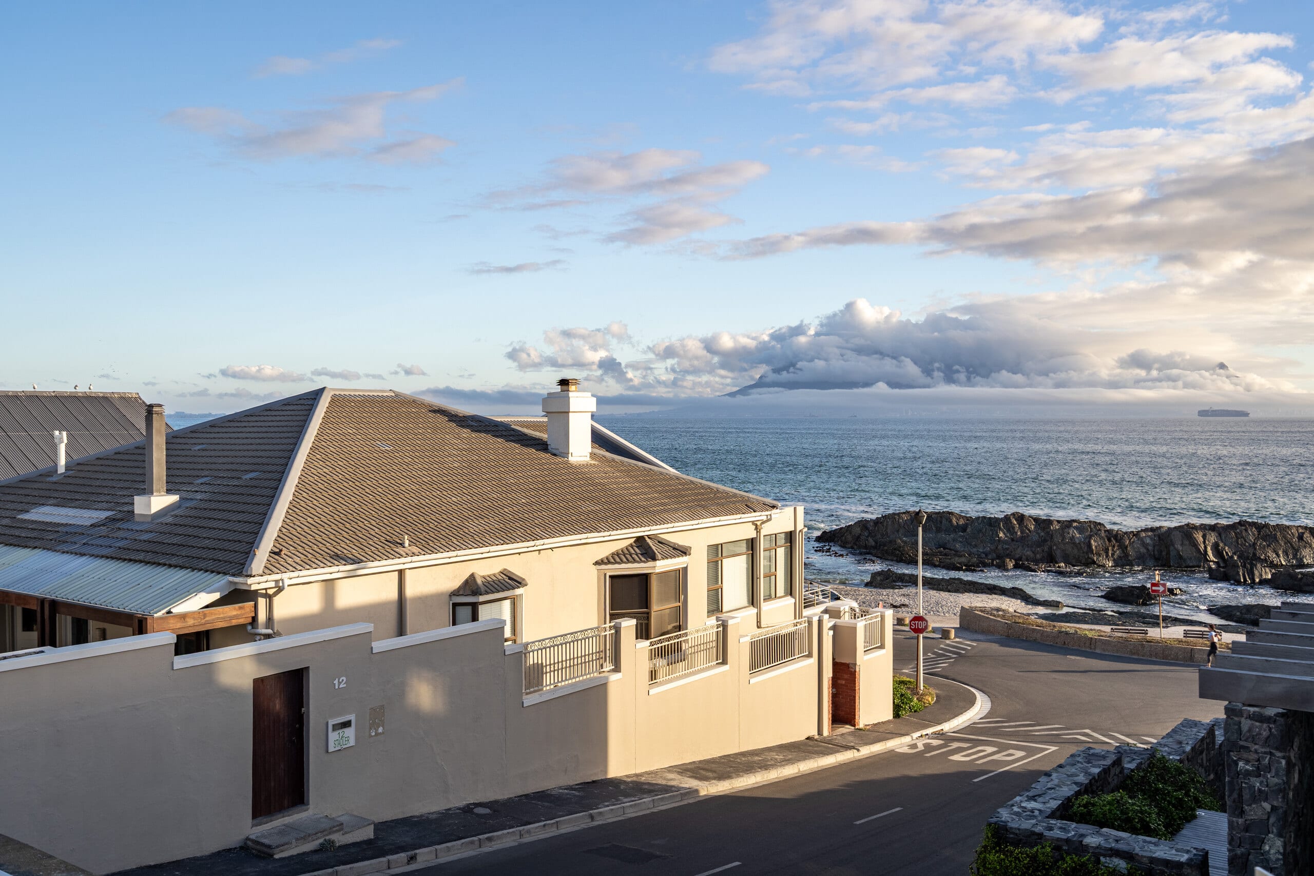 The Lighthouse seen from the shoreline with Table Mountain and the Cape Town skyline across Table Bay