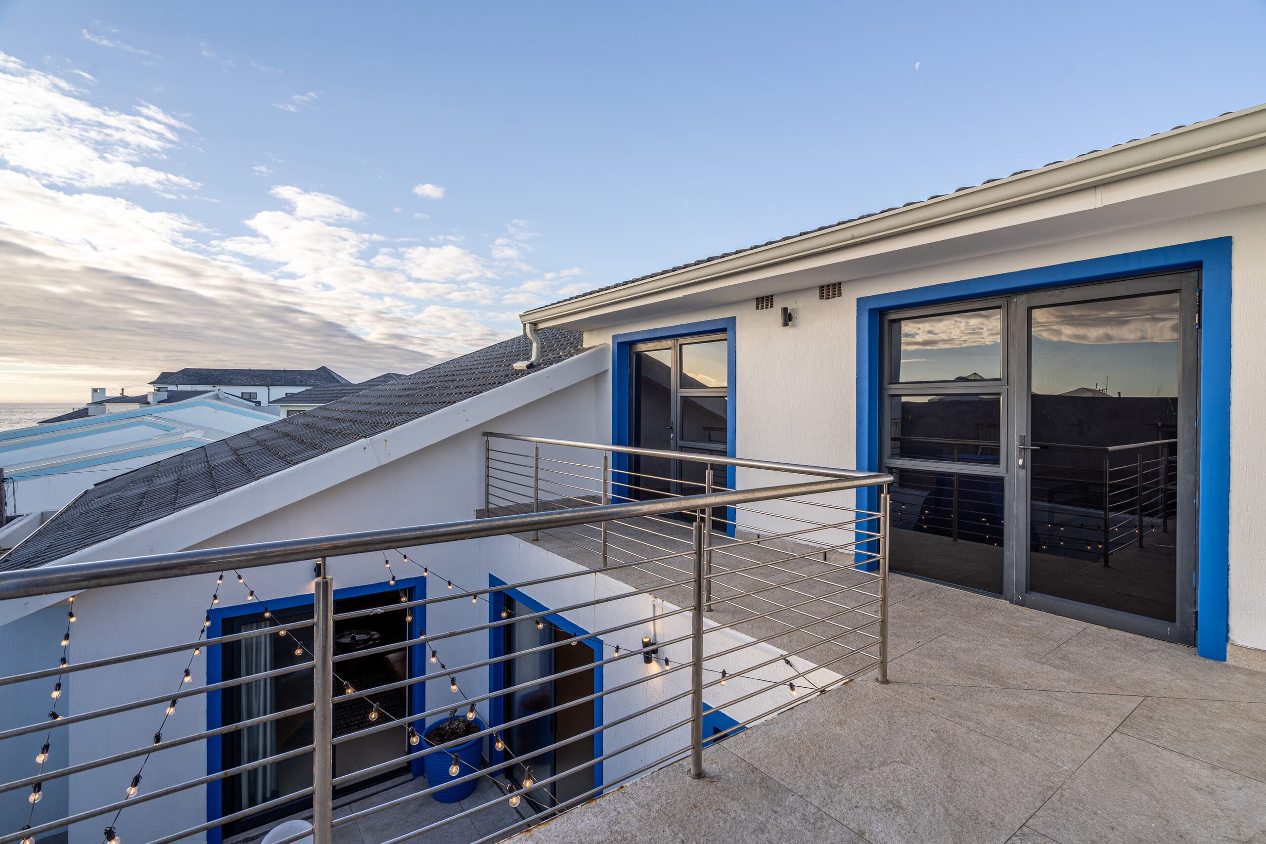 An elevated blue deck at The Lighthouse open to the sky